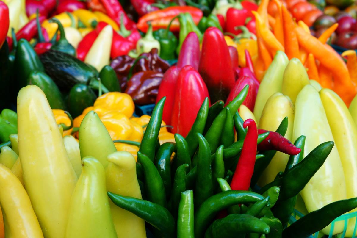 Colorful hot peppers are on display at a market.