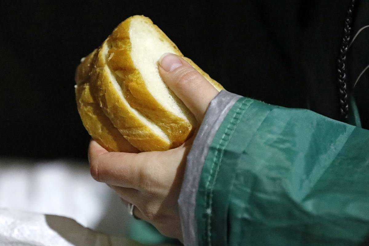 A person holds slices of bread.