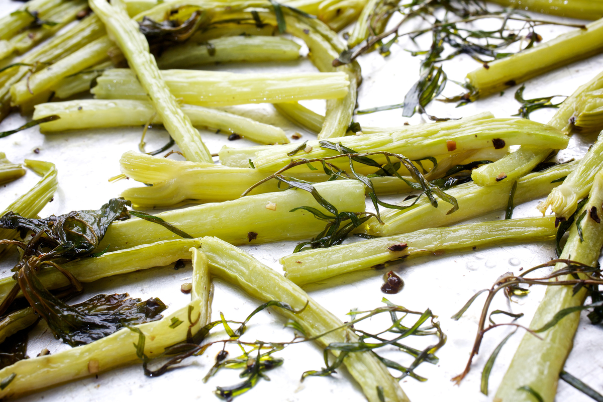 Roasted celery and tarragon lie on a pan.