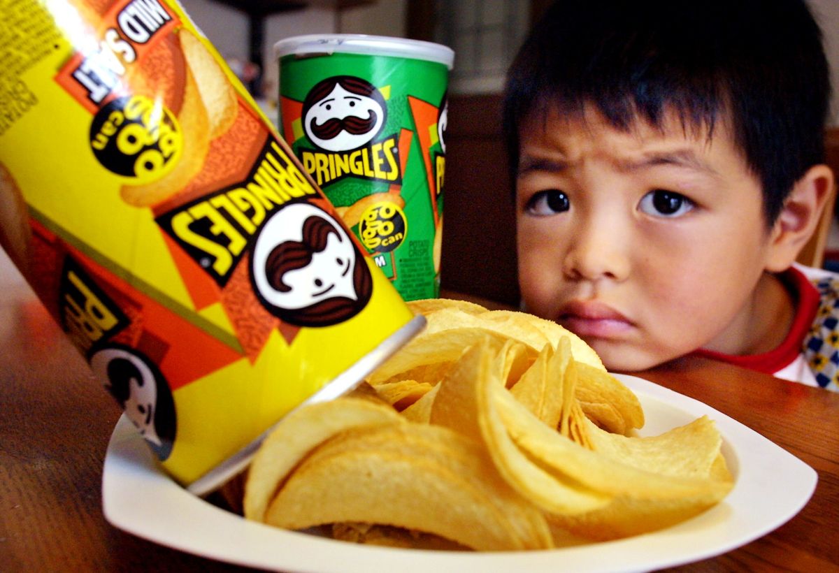 A Japanese boy looks wistfully at the Pringles' potato chips.