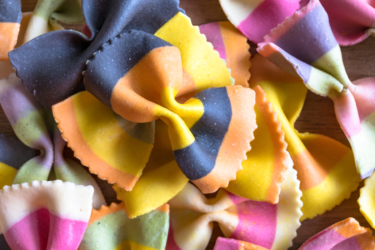 Pasta with vibrant, artificial colors is piled.