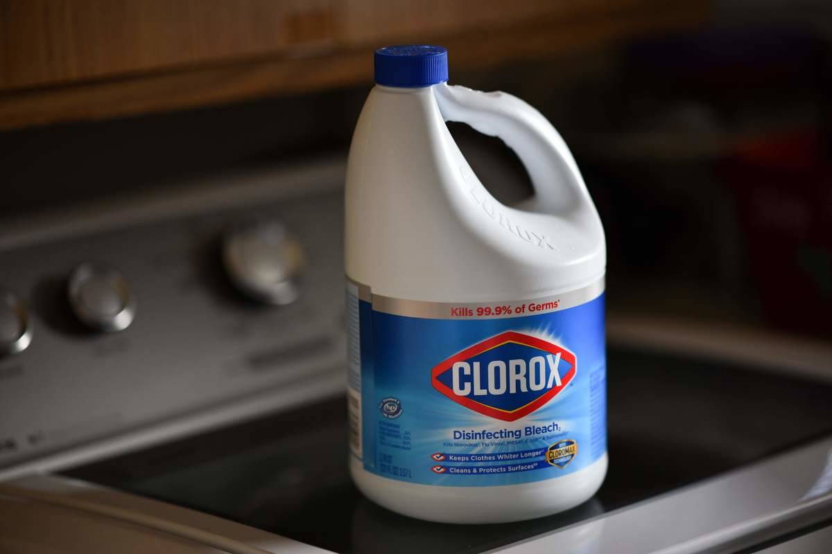 A container of Clorox bleach sits on a stovetop.