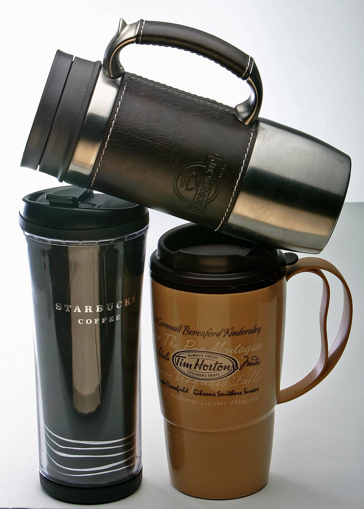 A travel mug is stacked on top of two others.